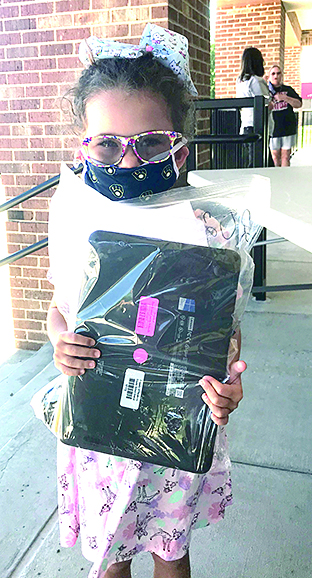Annie Redden picks up her laptop from Pendleton County Schools