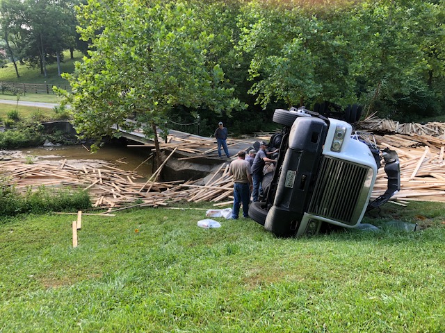 Lumber scattered all over the area around the creek and onto a private bridge, blocking the residents of the house for hours.