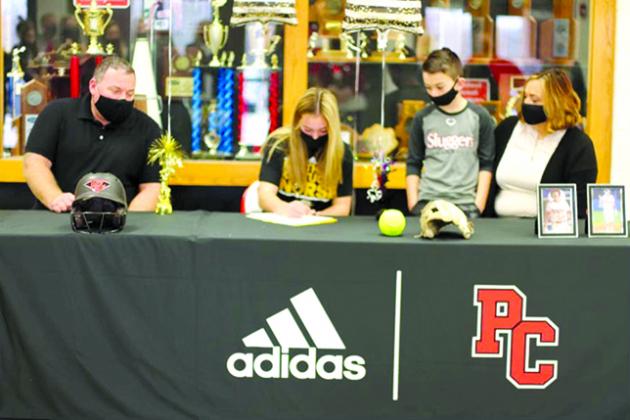 Pendleton County senior Raegan Carlisle signs her letter of intent to play Fastpitch Softball at Northern Kentucky University. Pictured from L-R: Larry Carlisle, Raegan Carlisle, Cason Carlisle, and Kelley Carlisle. Photo by Isabella Record.