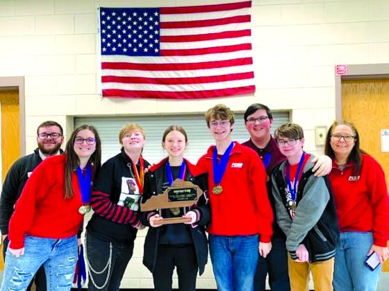 The current PCHS Academic Team team surrounds its first-place district trophy. PCHS's academic team has always been known for its strong showings in competition.
