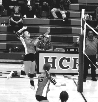 Skyla Harrison attacks the net for a spike against Robertson County. Photo courtesy of Sam McClanahan and Will Jones/10thregion.com