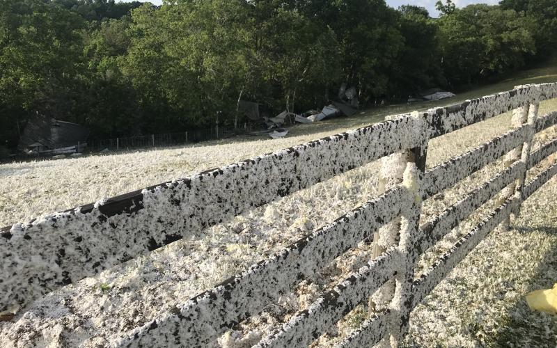 A home at the end of Veirs Road had its roof blown off and the insulation created a snow-covered visual covering fences, grass and vehicles.