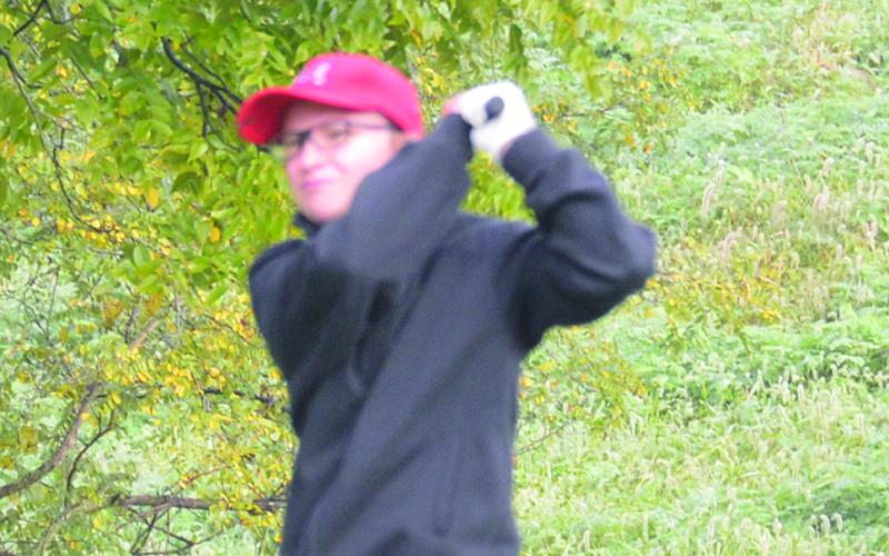 Shelby Eckart watches her drive on her first hole.