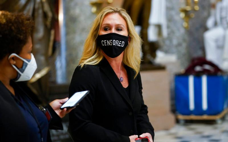 Rep. Marjorie Taylor Greene, R-Ga., walks on Capitol Hill in Washington, Wednesday, Jan. 13, 2021. (AP Photo/Susan Walsh)