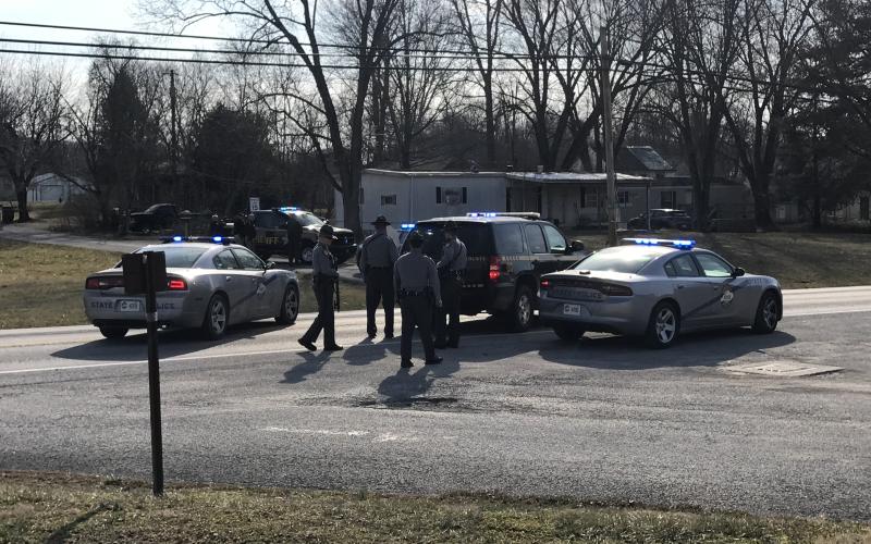 Multiple law enforcement agencies surround the trailer in Eastside Park