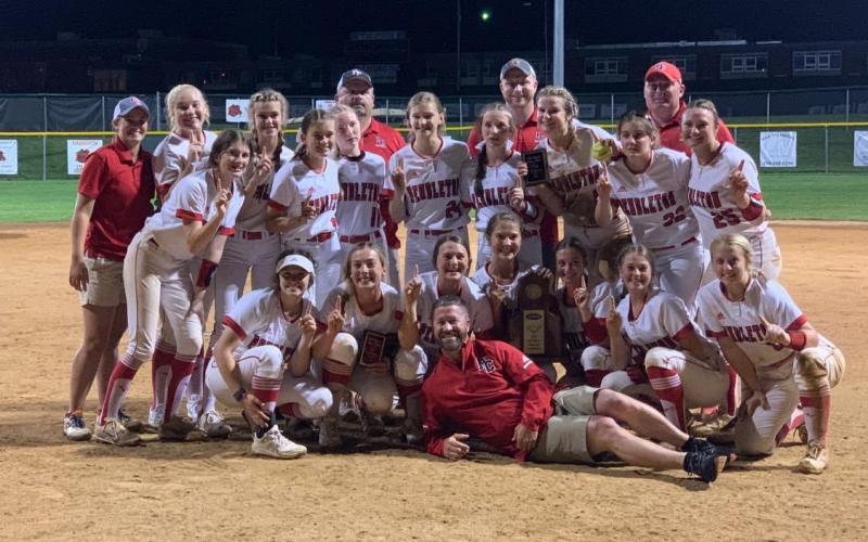 Ladycats Fast Pitch recreate their regional team championship photo with Superintendent Joe Buerkley