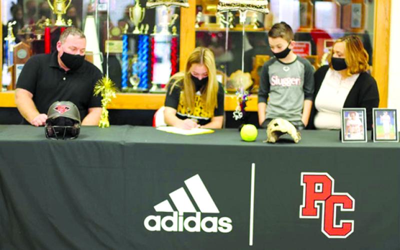 Pendleton County senior Raegan Carlisle signs her letter of intent to play Fastpitch Softball at Northern Kentucky University. Pictured from L-R: Larry Carlisle, Raegan Carlisle, Cason Carlisle, and Kelley Carlisle. Photo by Isabella Record.