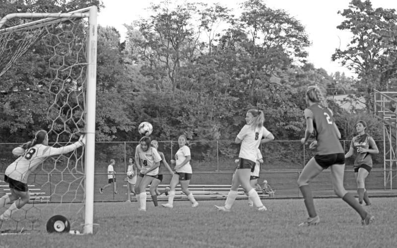 Eva Record moves on the backside of the goal towards the shot. Photo by Scott Collins