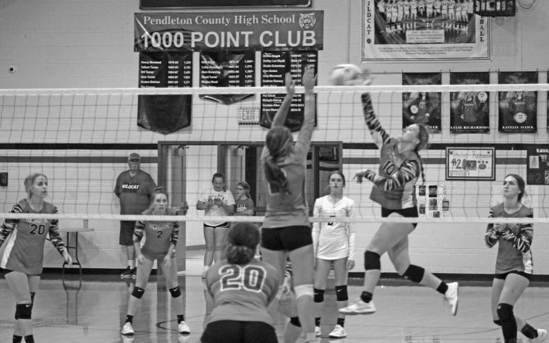 #10 Katelin Aulick is on the move as she soars through the air to play the ball back across the net. Photo by Scott Collins