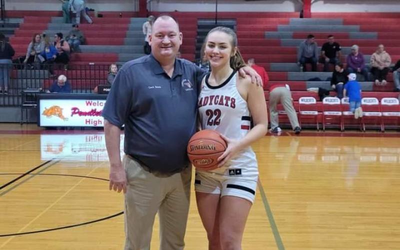Ladycats senior Cara Stewart was honored before the start of the home game versus Lloyd on Jan. 6. She became the 10th girl in team history to reach 1,000 points for her career. She accomplished that feat in the Jan. 4 road game at Grant County. She’s pictured with team head coach Patrick Kelsch.