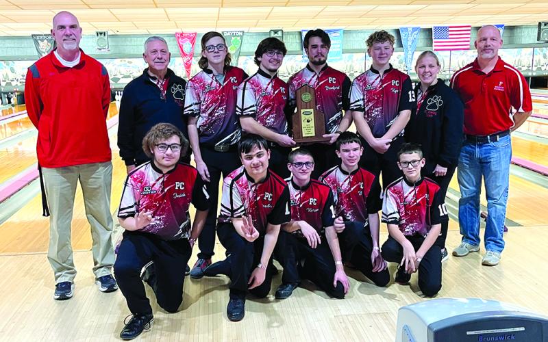 The Regional Champion Wildcats Bowling Team holds the trophy for their third Region 5 championship. The team is joined by Athletic Director Jon Wirth on the left and Principal Tony Dietrich on their right.