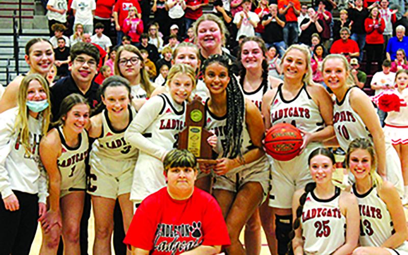 The Ladycats pose with the district trophy following their 21st win of the season. Photo by Stacey Myers.