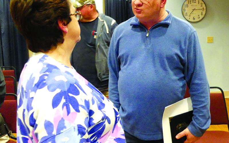Newly-hired police chief Marty Hart speaks with City Clerk Ramona Williams after the meeting that approved his hiring. Hart will begin as chief March 1.