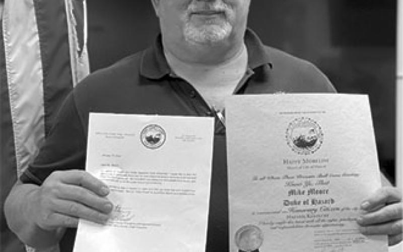 Mike Moore shows off the letter and certificate naming him an Honorary Duke of Hazard for his help during the recent disaster there.