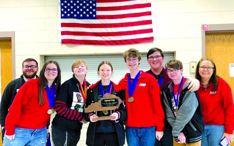 The current PCHS Academic Team team surrounds its first-place district trophy. PCHS's academic team has always been known for its strong showings in competition.