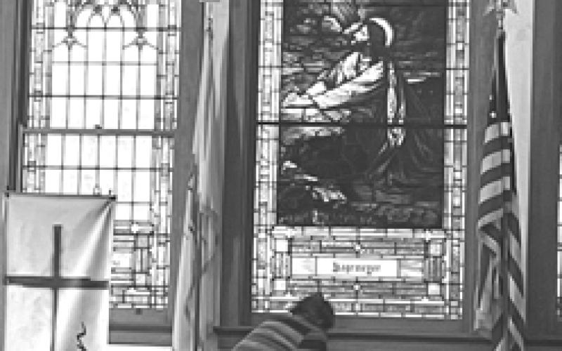A parishioner bows in prayer during the prayer service at Butler Methodist. Photo by Brenda Higgins.