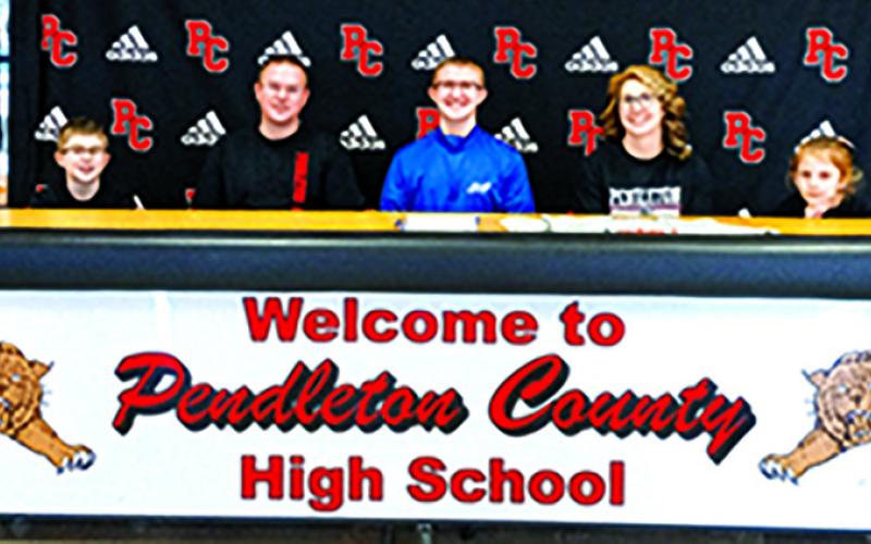 Austin Browning, center, is the first from PHS to sign as an Esports competitor at the college level. He will attend Thomas More University. Browning is pictured with his mother and father, Steve and Stephanie, and his siblings.