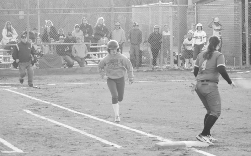 Logan Cooper attempts to bunt her way to first base. Photo by Sam McClanahan