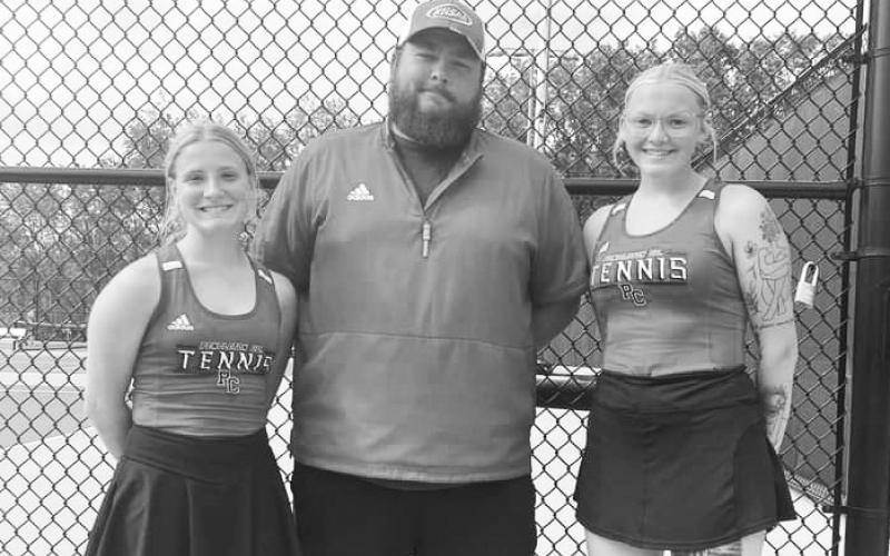 The Ladycats doubles team of Emmie Dunn (left) and Maddie Duff (right) are pictured with coach Dillon Feltner following their regional tournament wins that qualified them for the state tournament. Photo provided by Stacey Myers