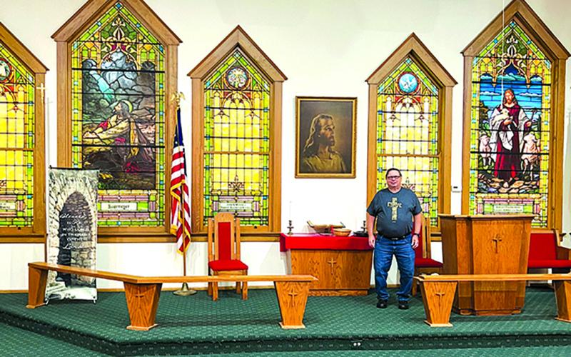 Minister Ron Schwarberg stands at the altar of Butler Christ Community Church. The church recently disaffiliated from the Methodist Council, and it is not alone. Methodist churches across the country took leave of the council by majority votes of the congregations after changes were made in procedure.