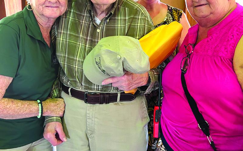 Billy Corbin, an original Kincaid Lake State Park Ranger, is surrounded by current maintenance employee Elsie Daugherty, former employee and Friends of the Park member Amy Hurst, and Mary McDowell.