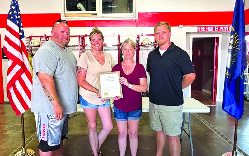David Marquardt’s family--son Ryan, daughter Kymberleigh, wife Cathy accept the proclamation from Falmouth Mayor Sebastian Ernst.