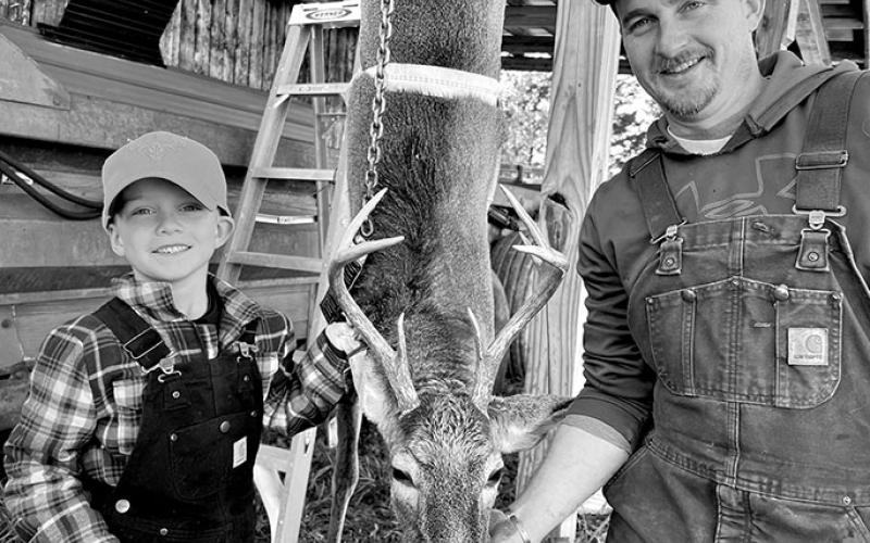 Bohan Ramsey poses with his dad, Doug Ramsey, with his first-ever deer. He used his Papaw Curtis's 243 rifle to take him down. Photo provided by Caitlin Ramsey.