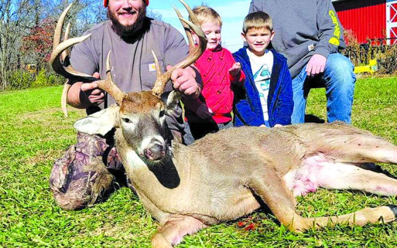 Steven Wright poses with his sons and his deer he got. "I killed the biggest buck of my life," he said.