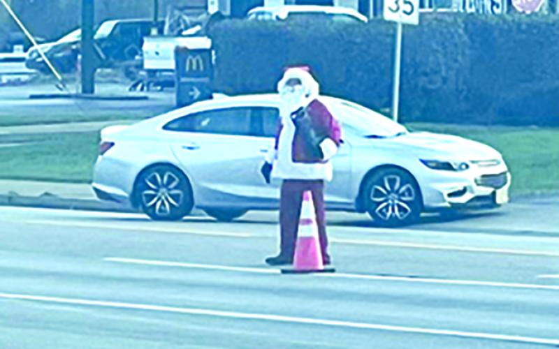 John Carson donned the Santa suit to collect for Shop with a Sheriff. He could be seen at the stop lights on U.S. 27 at both Butler and Falmouth.