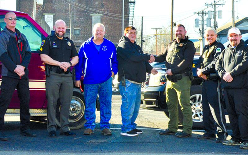 PC Search and Rescue met with the PC Sheriff, Butler Police and Falmouth Police Friday, December 15, to hand off the $2,700 they had collected in a fill-the-boot-type fundraiser for the Cops and Kids shopping event. Those present were Chris Lynch and Brian McCann of PCS&amp;R, Brody Schmeng of Falmouth Police, Darrin Brown and Scotty McElfresh of PCS&amp;R, Ken Hale of Butler Police, and Doug Smith and John Carson of PCS&amp;R. Photo by Jessie Beckett.
