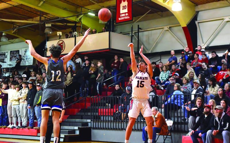 Sophomore Dawson Nichols fires a three-pointer from the corner. Scott defeated Pendleton County, 66-50. Photo by Sam McClanahan.