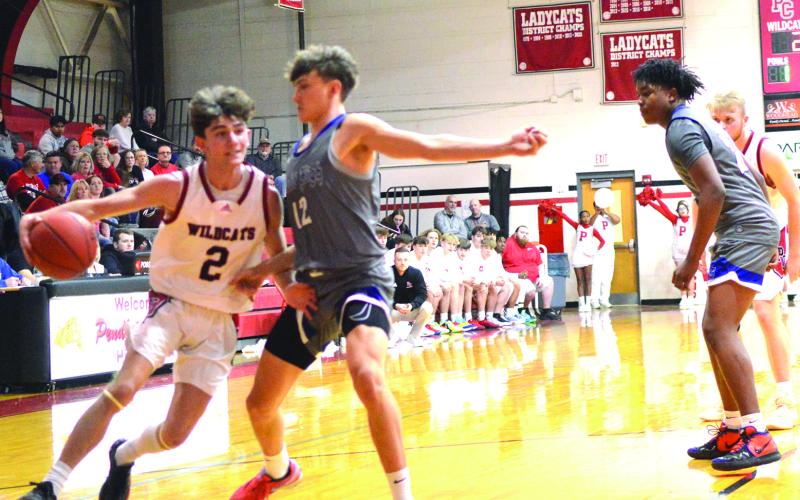 Wildcats senior Alex Beyst looks to get by his defender while driving to the basket during the teams January 5 contest with Scott High. Beyst led the Wildcats with 19 points. Photo by Sam McClanahan.