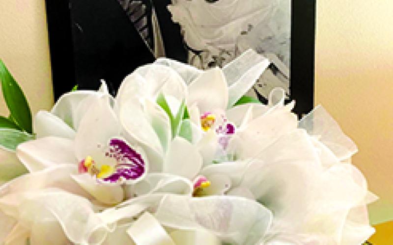 A bouquet of orchids sits in front of a photo from the Klees' wedding day on Jan. 15, 1949. Photo provided by Marianne Klee Roseberry.