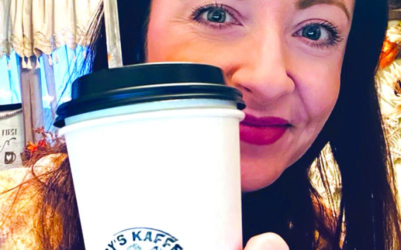 Megan Leasher, a Northern Ohio native who now resides in Newport, or, as she prefers to call it, “the Port of New,” displays her Trappy’s refreshment, a purchase she made in her first stop in her first expedition to Falmouth.