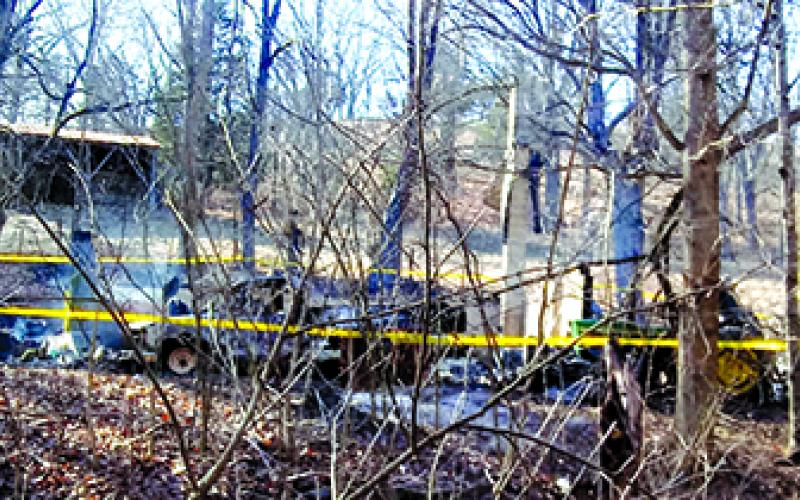 The remains of home at 2887 River Road, Butler, continue to smolder last Wednesday afternoon. The resident, Noble Gabbard Jr., 47, lost his life. A wood stove is blamed as the cause of the house fire. Photo by Burton Cole.