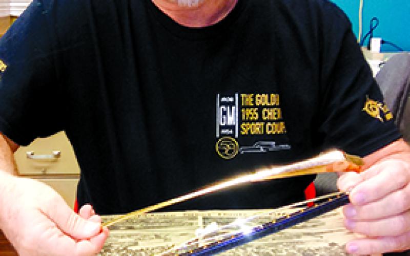 Steve Blades discusses the gold-plated windshield wipers that were manufactured Oct. 18, 1954, for the golden 1955 Chevrolet Bel Air Sport Coupe General Motors built to mark its 50 millionth car, which was completed Nov. 23, 1954. Photo by Burton Cole.