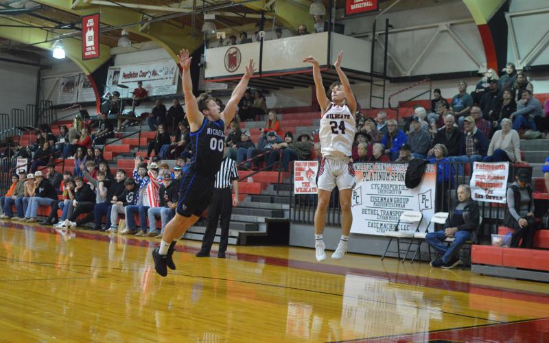 Wildcat junior Luke Gregg fires a three from the corner during the team's home game against Nicholas County on Feb. 12. Photo by Sam McClanahan.