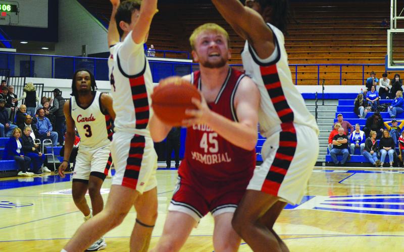 Senior Austin Kirsch muscles his way through the double-team for a basket against GRC.