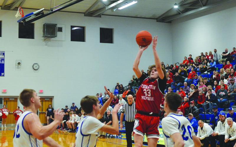Wildcats junior Aden Merrill rises above the Nicholas County defense for the jumper during their district semifinal game. Photo by Sam McClanahan.