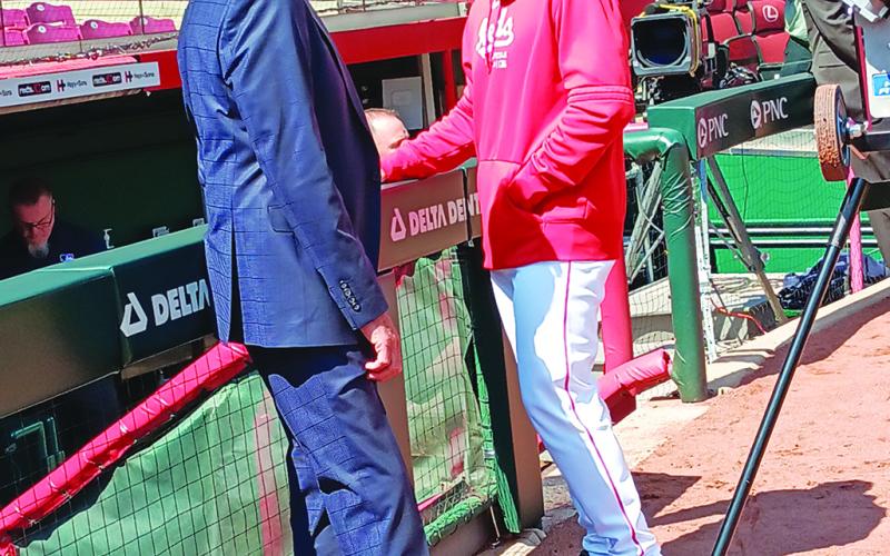 Longtime Reds television and radio broadcaster Chris Welsh, left, chats with David Bell during batting practice.