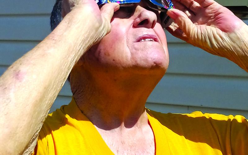 George Lonaker, 79, of Falmouth, watches from his yard on Liberty Street in Falmouth. Photo by Angela Fleming.