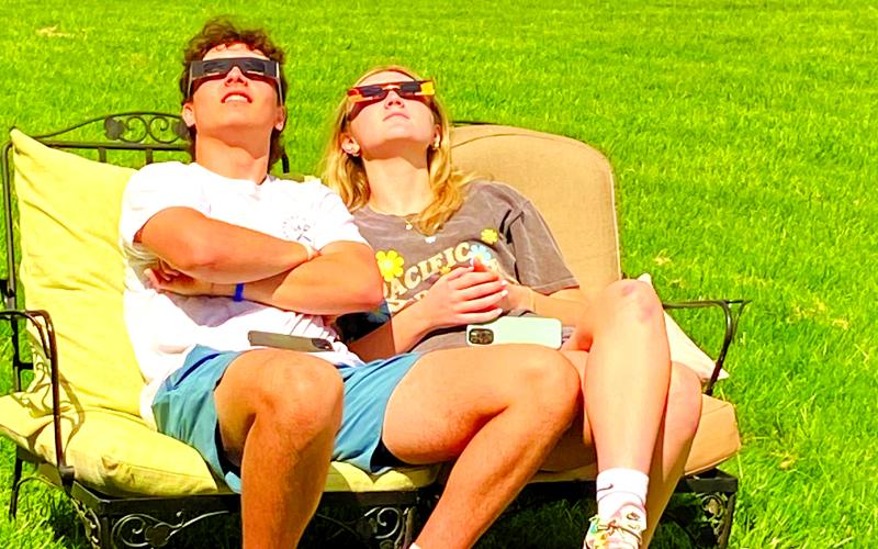 Matteo Romeo of Falmouth and his girlfriend, Tori Cravens of Cincinnati, watch the eclipse from the Romeo family farm on Liberty Ridge. Photo by Patricia Romeo.
