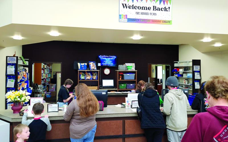Patrons line up to check out materials Saturday at the Pendleton County Public Library’s Grand Reopening. Two hundred people turned out to see the renovations and new features completed since the library closed to in-person visits on Oct. 9.