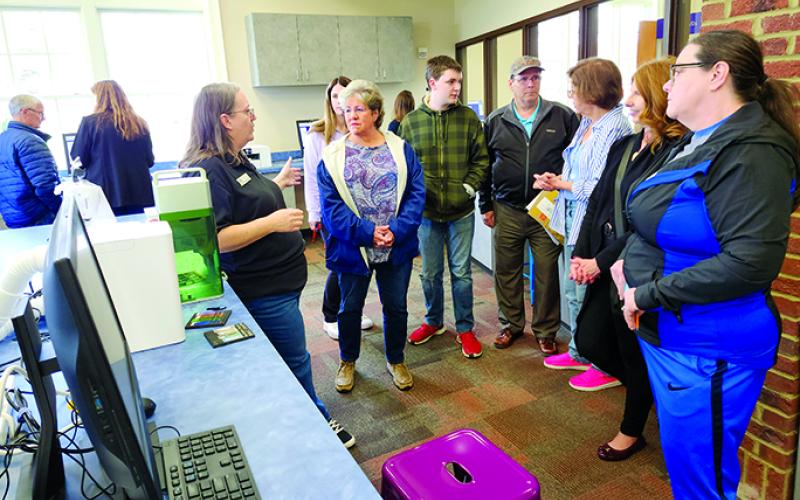 Trish Niehuas, assistant library director, explains the new creative equipment in the MakerSpace. Photos by Burton Cole.