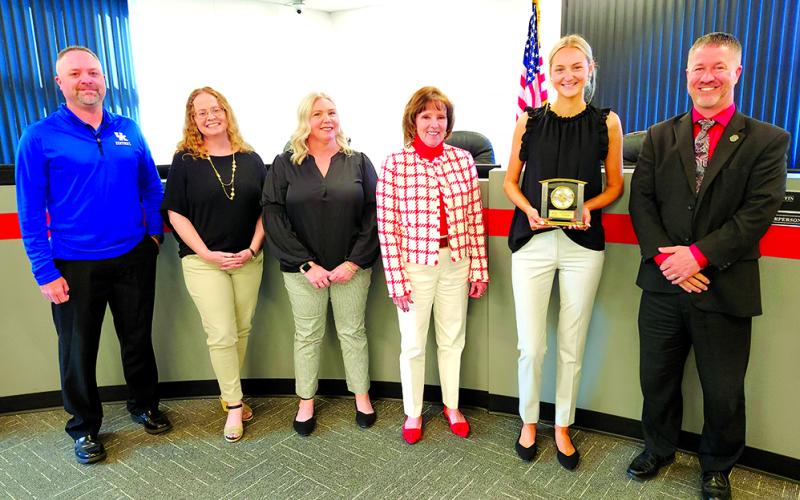 Congratulating Pendleton County High School senior Ava Record for her term on the Board of Education are, from left, board members Derek Brown, Laura Schack, Amber Bebe and Cheryl Griffin; Record; and district Superintendent Joe Buerkley. Photo by Burton Cole.