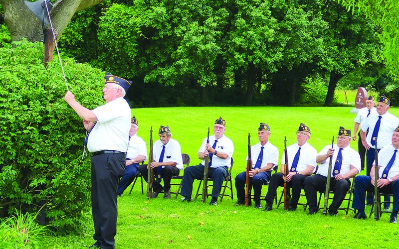 Johnnie Parsons rings the bell as names of the six American Legion Post 109 members who have died since last year’s Memorial Day are read.