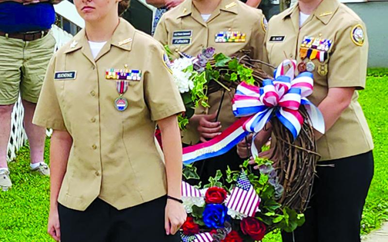 Pendleton County High School Navy Junior Reserve Officers Training Corps cadets, from left, Sierra Deatherage, Catalina Furman and Georgia Oliver prepare to place a wreath in honor of fallen military personnel during Memorial Day ceremonies May 26 outside the Hardin Browning American Legion Post 109 in Falmouth. A severe storm that moved in that afternoon shortened the outdoor services, and the rest of the program, including the keynote address by Evan Meyer, pastor of Antioch Mills Christian Church, was mo