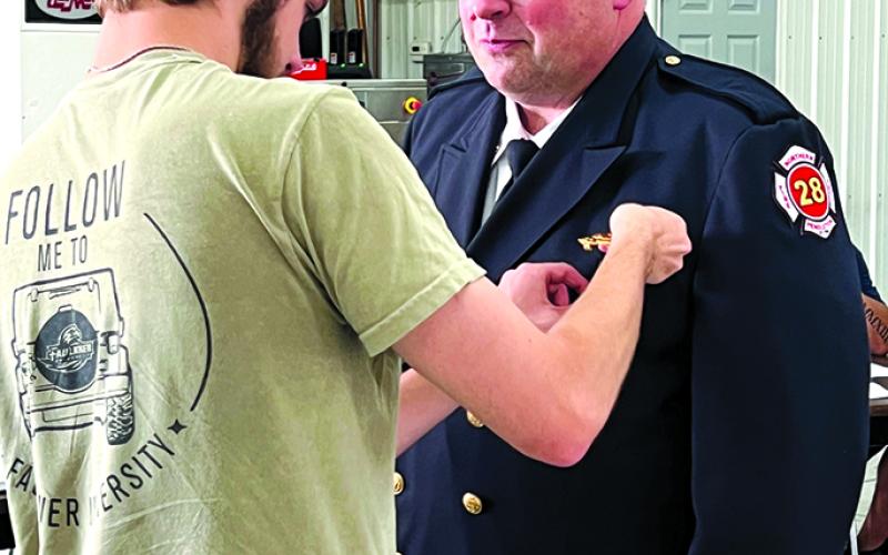 NPFD Chief Adam Fuller receives his Chief's badge.