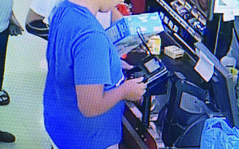 Surveillance video of man installing skimmer device