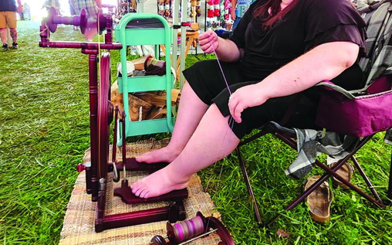Margeaux Gibson spins wool.